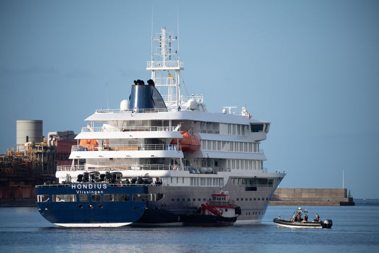 Boats approach the Dutch flagged hantavirus-stricken cruise ship MV Hondius after it arrived at the industrial port of Granadilla de Abona on the island of Tenerife in Spain's Canary Islands on May 10, 2026