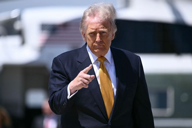 US President Donald Trump gestures prior boarding Air Force One at Joint Base Andrews, Maryland, on May 12, 2026 as he departs for a 3-day state visit to China.