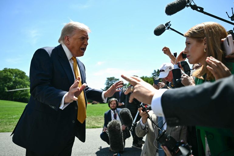 TOPSHOT - US President Donald Trump speaks to the press before walking to board Marine One as he departs from the South Lawn of the White House in Washington, DC, on May 12, 2026.