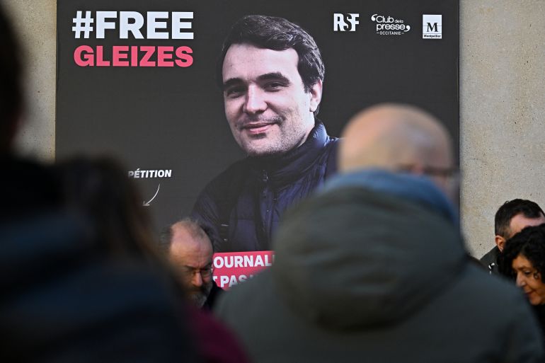 (FILES) A portrait of French journalist Christophe Gleizes, who is detained in Algeria, is unveiled during a demonstration organised by the Occitanie Press Club and rights group Reporters Without Borders (RSF) to demand his release in Montpellier, southern France on January 29, 2026.