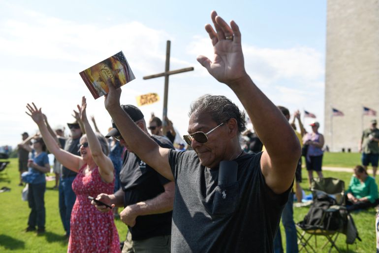 afp_6a098394971b-1779008404 Christian worshipers raise their hands as faith leaders pray during the Roots of Revival event at the Washington Monument, held a day ahead of "Rededicate 250: A National Jubilee of Prayer, Praise and Thanksgiving" in Washington, DC, on May 16, 2026.