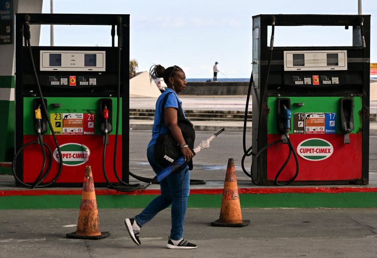 A woman walks past an empty petrol station in Havana on May 15, 2026.