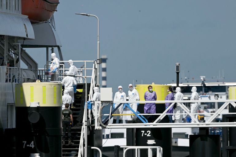 afp_6a0b19e18088-1779112417 Responders wearing protective suits enter the Dutch Hantavirus-hit cruise ship MV Hondius after its arrival at the port of Rotterdam on May 18, 2026.
