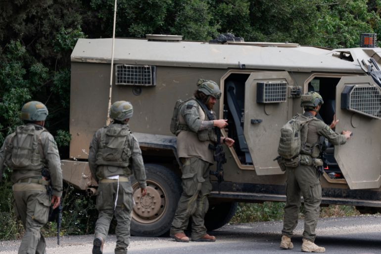 afp_6a0eb0b8cbb5-1779347640 Israeli soldiers react after taking cover near the Israel-Lebanon border following a Hezbollah drone attack that hit the northern border on May 19, 2026.
