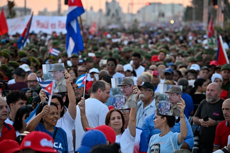 afp_6a10a4ebb29b-1779475691 Women hold photographs of former Cuban president Raul Castro, 94, who has been indicted by a US court, during a rally outside the US Embassy in Havana on May 22, 2026. (Photo by ADALBERTO ROQUE / AFP)