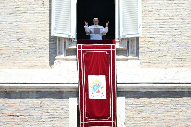 Pope Leo XIV addresses the crowd from the window of the apostolic palace overlooking St. Peter's square during the Regina Caeli prayer in The Vatican on May 24, 2026. (Photo by Andreas SOLARO / AFP)