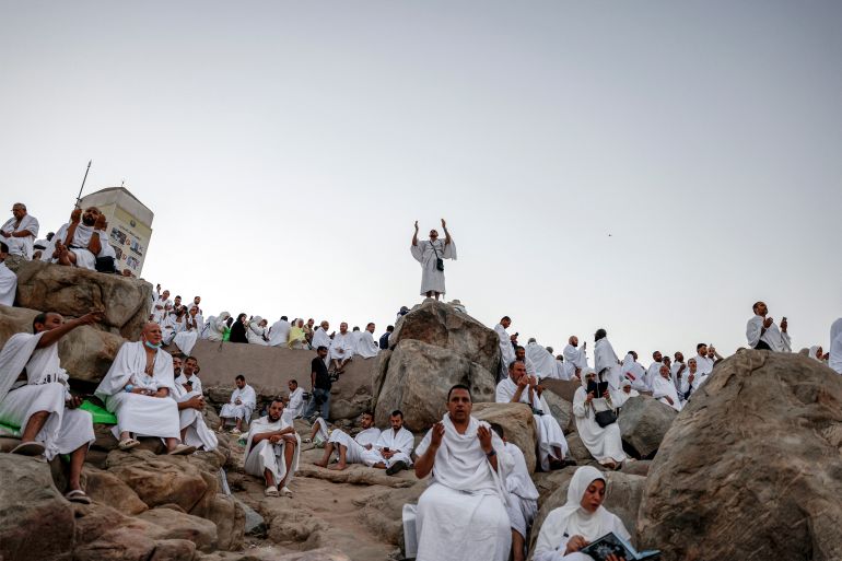 TOPSHOT - Muslim pilgrims pray on Saudi Arabia's Mount Arafat, also known as Jabal al-Rahma or Mount of Mercy, during the climax of the Hajj pilgrimage early on May 26, 2026.