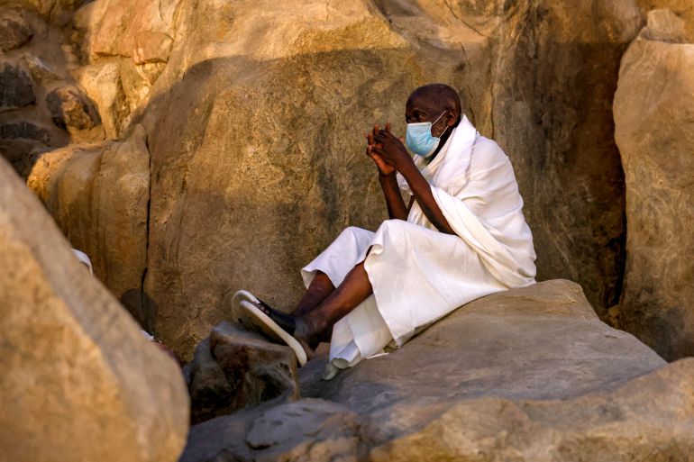 A Muslim pilgrim prays at dawn near Saudi Arabia's Mount Arafat, also known as Jabal al-Rahma or Mount of Mercy, during the climax of the Hajj pilgrimage on May 26, 2026.
