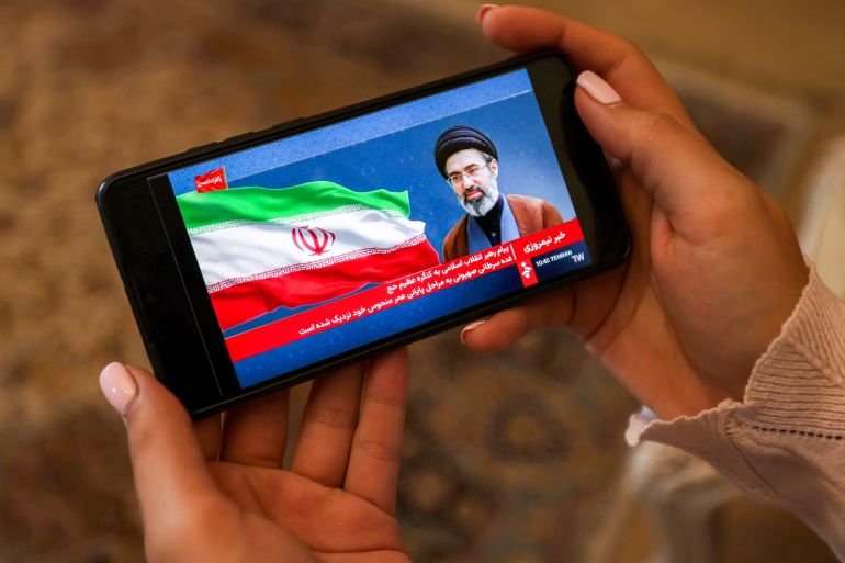 afp_6a1637db24a8-1779840987-1 A woman watches a televised broadcast delivered on behalf of Iran's Supreme Leader Mojtaba Khamenei in Tehran on May 26, 2026.