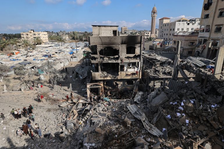 afp_6a17431b9419-1779909403 Palestinians inspect the rubble at the site of a residential building targeted overnight by an Israeli strike, following a warning from the Israeli military to evacuate, in Deir el-Balah in the central Gaza Strip, on May 24, 2026.