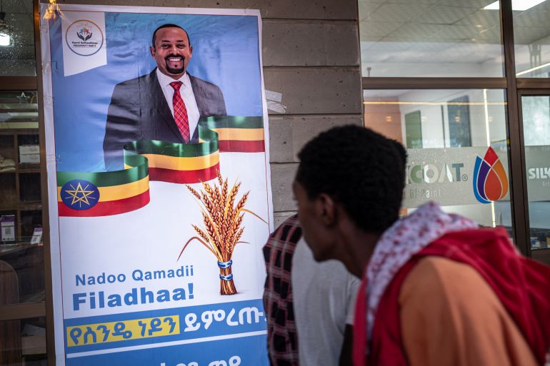 afp_6a18167d894c-1779963517 People walk past an election campaign poster depicting Ethiopia’s Prime Minister Abiy Ahmed in Jimma on May 27, 2026 ahead of Ethiopia’s general elections scheduled for June 1, 2026. (Photo by Marco Simoncelli / AFP)