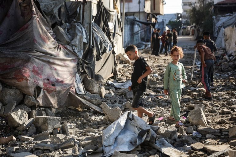 afp_6a187d27e23b-1779989799 Two Palestinian children walk through the site of an overnight Israeli military strike on structures and tents housing displaced families, killing ten Palestinians, in Gaza City on May 28, 2026.