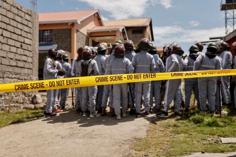 afp_6a1896a67887-1779996326 Kenyan administration policemen gather for a briefing at the Utumishi Girls Academy following the deadly fire in Gilgil, north of the capital Nairobi on May 28, 2026.