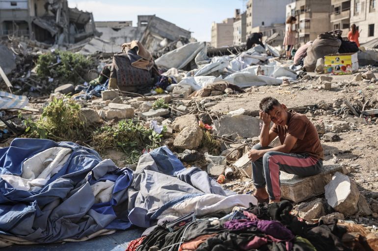 TOPSHOT - A Palestinian boy sits at the site of an overnight Israeli military strike on structures and tents housing displaced families, killing ten Palestinians, in Gaza City on May 28, 2026.