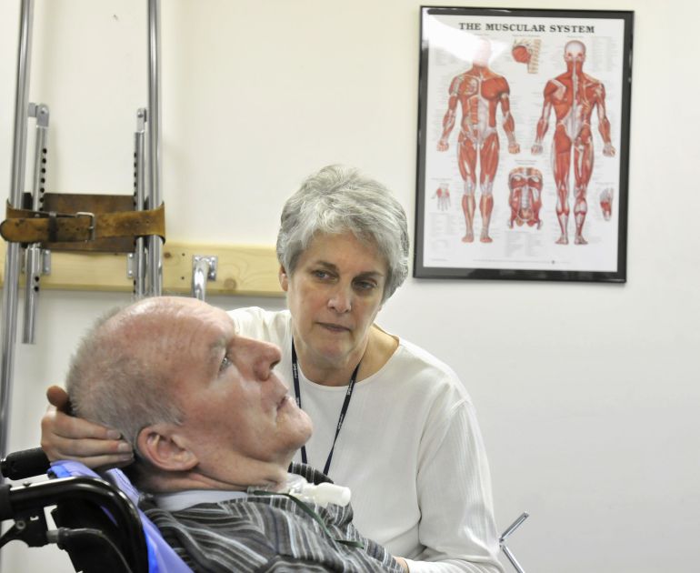 **APN ADVANCE FOR SUNDAY FEB.8** Bonnie Veillette looks at her husband Bob at the end of his physical therapy session in Brookfield, Conn., Tuesday, Dec. 9, 2008. Bob Veillette suffered a stroke in April 2006 that left him with locked-in syndrome, a rare neurological condition that leaves a person paralyzed below the eyes but totally cognizant of the world around them. (AP Photo/Jessica Hill)