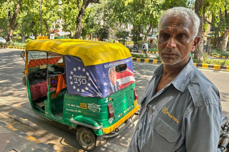 ap26140275256652-1779312968 Ganesh Kumar stands next to his auto-rickshaw featuring a poster of U.S. President Donald Trump that celebrates "250 Years of America" on the back of his vehicle in New Delhi, India, Wednesday, May 20, 2026. (AP Photo/Piyush Nagpal)