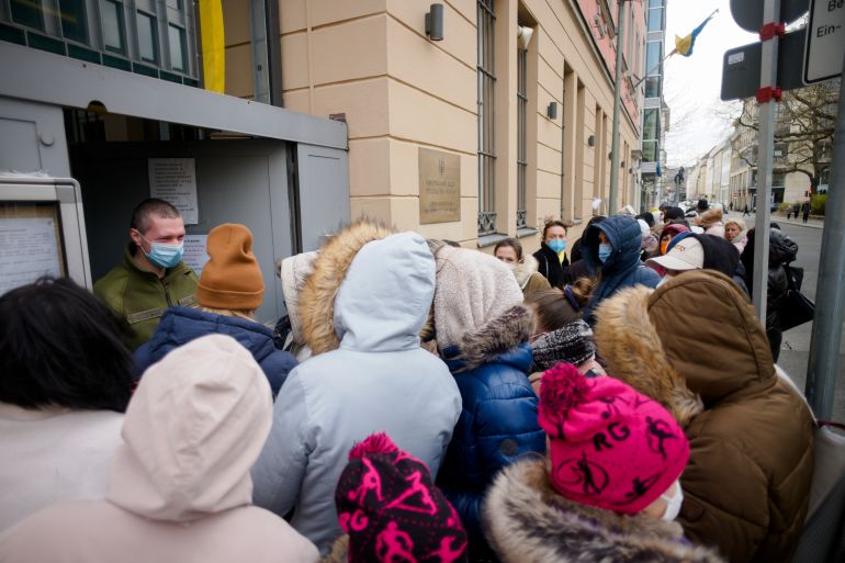 FILE --People from the Ukraine most of them refugees fleeing the war, wait in front of the consular department of the Ukrainian embassy in Berlin, Germany, Friday, April 1, 2022. German government pledged Tuesday to provide more support to cities and towns struggling to house more than 1.1 million refugees who have arrived in the country this year mostly from war-torn Ukraine but also other countries such as Syria and Afghanistan.(AP Photo/Markus Schreiber,file)