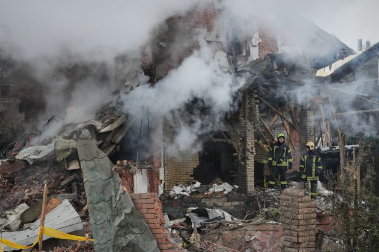 Firefighters put out a fire after a drone hit a residential building during a Russian air attack in Kyiv, Ukraine, Sunday, Feb. 22, 2026. (AP Photo/Sergei Grits)