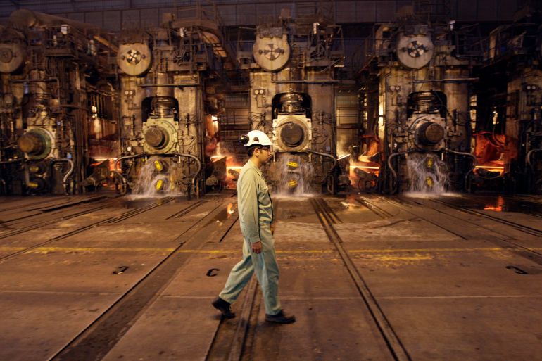 In this photo taken on Thursday, May 31, 2012, an Iranian worker walks past a part of hot rolling mill of the Mobarakeh Steel Complex, some 280 miles (460 kilometers) south of the capital Tehran, and some 40 miles, 65 kilometers, southwest of central Iranian city of Isfahan. (AP Photo/Vahid Salemi)