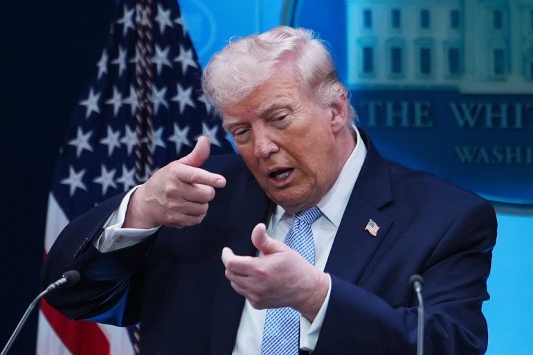 FILE - President Donald Trump pretends to aim a sniper gun while speaking with reporters in the James Brady Press Briefing Room at the White House in Washington, April 6, 2026. (AP Photo/Julia Demaree Nikhinson, File)