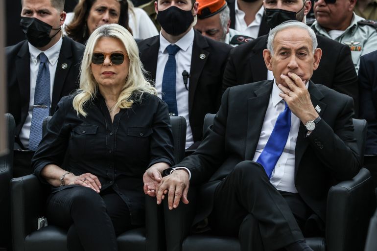 Israel's Prime Minister Benjamin Netanyahu, right, and his wife Sara attend a ceremony commemorating Israel's Remembrance Day for fallen soldiers, or Yom HaZikaron, at the Military Cemetery on Mount Herzl in Jerusalem, Tuesday April 21, 2026. (Ilia Yefimovich/Pool Photo via AP)