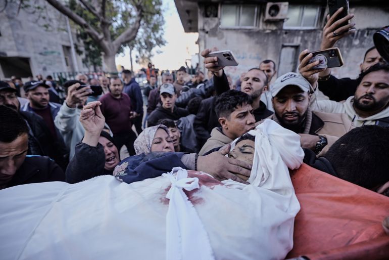 Mourners carry the body of Mahmoud Sahwil, 14, who was killed in an Israeli airstrike targeting a police station in Gaza City, Tuesday, May 5, 2026. (AP Photo/Jehad Alshrafi)