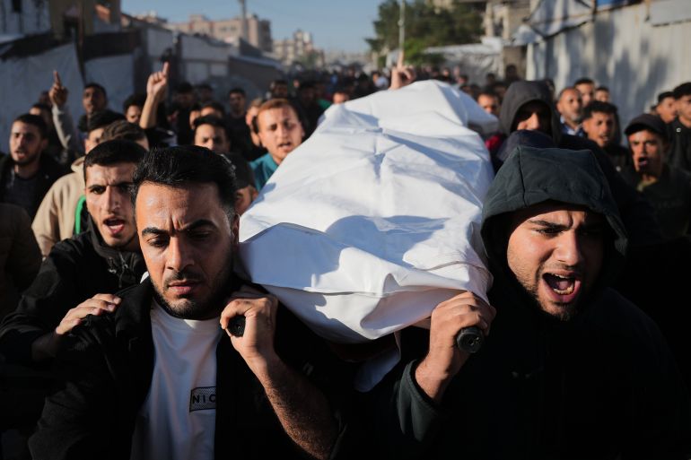 Palestinians carry the body of Naseem Al-Kalzani, who was killed in an Israeli strike, during his funeral at Nasser Hospital in Khan Younis, southern Gaza Strip, Wednesday, May 6, 2026. (AP Photo/Abdel Kareem Hana)