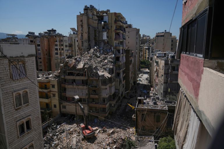 Rescue workers search through the rubble of a building destroyed in an Israeli airstrike the previous day in Dahiyeh, Beirut's southern suburbs, Lebanon, Thursday, May 7, 2026. (AP Photo/Bilal Hussein)
