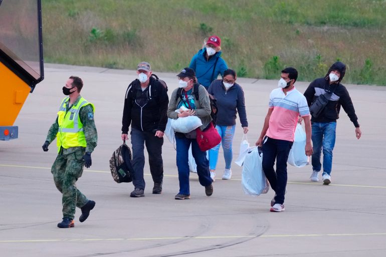 Passengers evacuated from the hantavirus-stricken cruise ship MV Hondius arrive at Eindhoven airport, Netherlands, Sunday, May 10, 2026. (AP Photo/Peter Dejong)