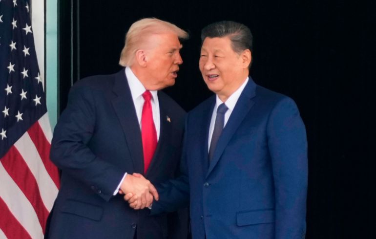 ap_6a027aa56d9b2-1778547365 FILE - President Donald Trump, left, and Chinese President Xi Jinping, shake hands after their U.S.-China summit talk at Gimhae International Airport Jinping in Busan, South Korea, Oct. 30, 2025. (AP Photo/Mark Schiefelbein, File)