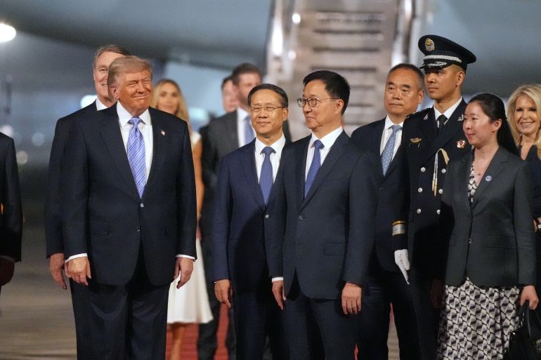 President Donald Trump pauses with China's Vice President Han Zheng during an arrival ceremony Wednesday, May 13, 2026, at Beijing Capital International Airport in Beijing. (AP Photo/Mark Schiefelbein)