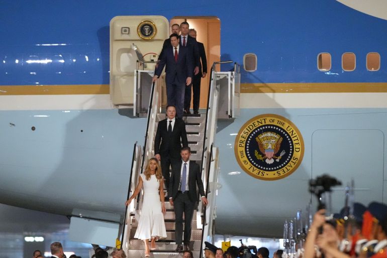 Eric and Lara Trump, followed by Elon Musk, Secretary of State Marco Rubio, Defense Secretary Pete Hegseth, U.S. Trade Representative Jamieson Greer and NVIDIA CEO Jensen Huang, walk from Air Force One after arriving with President Donald Trump, Wednesday, May 13, 2026, at Beijing Capital International Airport in Beijing. (AP Photo/Mark Schiefelbein)