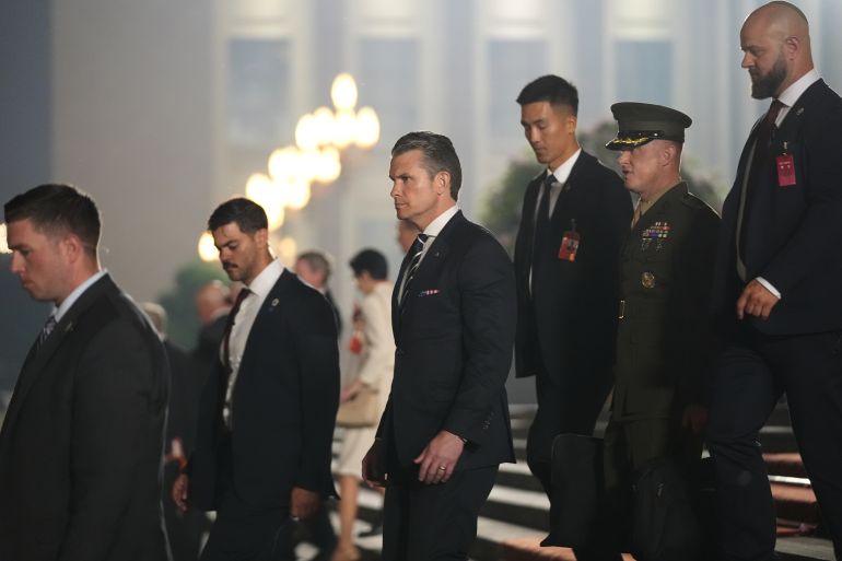 Secretary of Defense Pete Hegseth, center, leaves after attending a state dinner with President Donald Trump and Chinese President Xi Jinping at the Great Hall of the People on Thursday May 14, 2026, in Beijing. (AP Photo/Mark Schiefelbein)