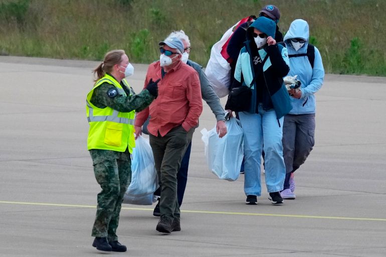 Passengers evacuated from the hantavirus-stricken cruise ship MV Hondius arrive at Eindhoven airport, Netherlands, Sunday, May 10, 2026. (AP Photo/Peter Dejong)
