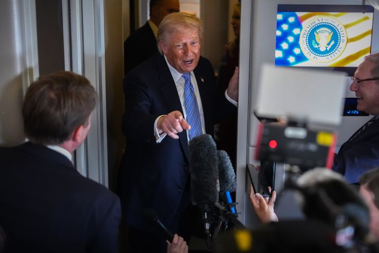 President Donald Trump speaks to reporters aboard Air Force One, Friday, May 15, 2026, as he returns from a trip to Beijing, China. (AP Photo/Mark Schiefelbein)