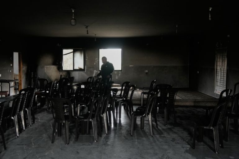Imam Saber Shalash stands in a fire-damaged room of the local mosque following an attack by Israeli settlers, condemned by Palestinian authorities, in the West Bank village of Jibiya, northwest of Ramallah, Friday, May 15, 2026. (AP Photo/Majdi Mohammed)