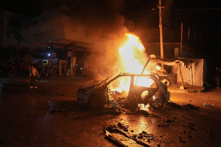 ap_6a076e014a77a-1778871809-1 Flames engulf a vehicle struck by an Israeli strike in a street of Gaza City, Friday, May 15, 2026. (AP Photo/Jehad Alshrafi)
