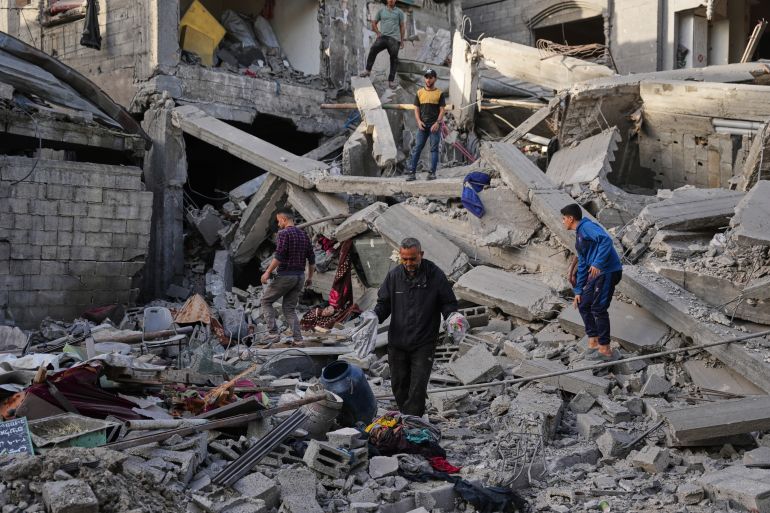 Palestinians inspect the rubble of the Abu Shamala family home, destroyed in Israeli airstrike at the Bureij refugee camp in the central Gaza Strip Wednesday, May 20, 2026. (AP Photo/Abdel Kareem Hana)