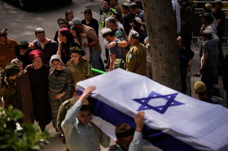 ap_6a0e59fa81bae-1779325434 Israeli soldiers carry the flag-draped casket of Capt. Maoz Israel Recanati who was killed in a Lebanese drone attack in southern Lebanon, during his funeral in Mt. Herzl military cemetery in Jerusalem, Sunday, May 17, 2026. (AP Photo/Ohad Zwigenberg)