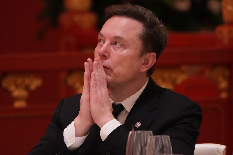 ap_6a0eae044405a-1779346948 Elon Musk listens to the speech of Chinese President Xi Jinping during a state dinner with President Donald Trump at the Great Hall of the People on Thursday May 14, 2026, in Beijing. (AP Photo/Mark Schiefelbein)