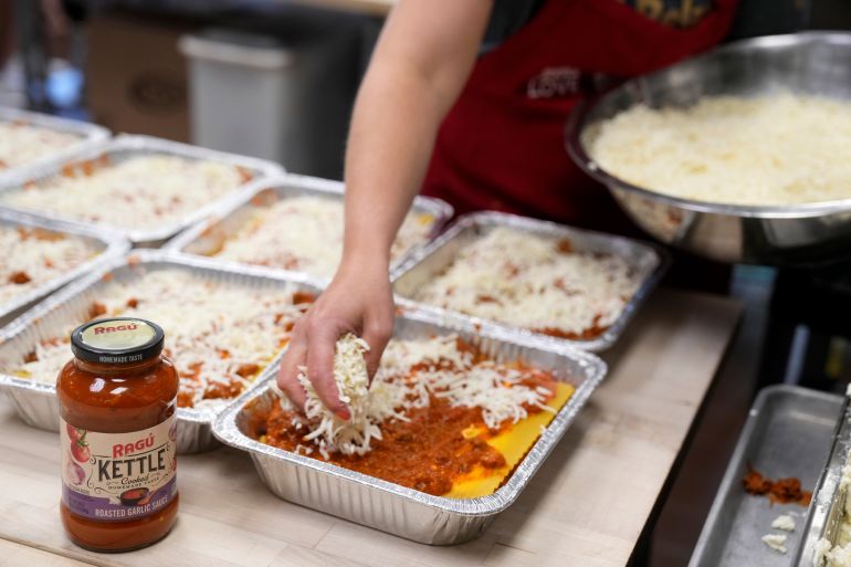 ap_6a149839b3ce2-1779734585 IMAGE DISTRIBUTED FOR RAGÚ - Local-area Lasagna Love volunteers prepare their signature dishes for delivery with RAGÚ® Kettle Cooked Roasted Garlic Sauce at Paramus Tech Culinary Department on Friday, July 26, 2024 in Paramus, N.J. (Charles Sykes/AP Content Services for RAGÚ)