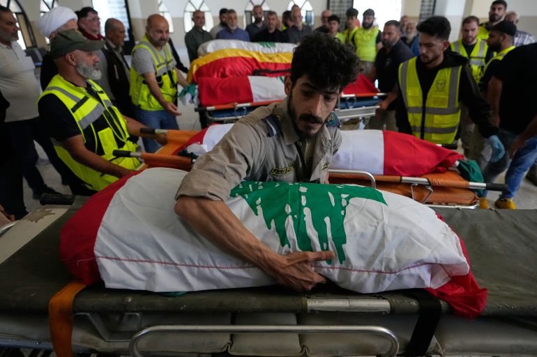 ap_6a19e8e3ef9e8-1780082916 A paramedic volunteer lays the body one of the six family members on a stretcher after they were killed on Wednesday when their car was struck in an Israeli airstrike on a highway as they fled their village, during a funeral procession in the southern port city of Tyre, Lebanon, Friday, May 29, 2026. (AP Photo/Mohammed Zaatari)