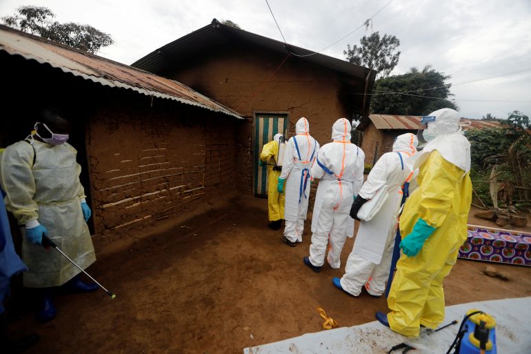 asdasd-1764658442-1 FILE PHOTO: Kavota Mugisha Robert (L), a healthcare worker who volunteered in the Ebola response, stands with decontamination gear as his colleague prepare to enter a house where a woman, 85, is suspected of dying of Ebola in the Eastern Congolese town of Beni in the Democratic Republic of Congo, October 8, 2019. REUTERS/Zohra Bensemra/File Photo