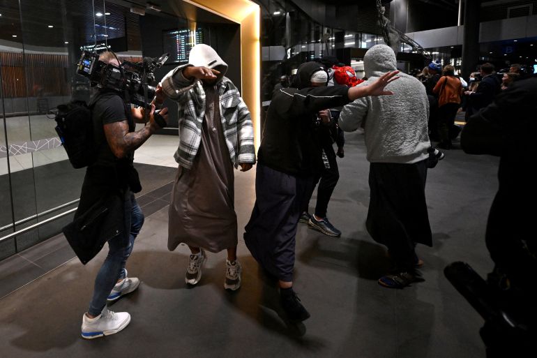 A group of supporters surround an Islamic State-linked family, as they arrive at Melbourne international airport, in Melbourne, Australia, May 7, 2026. 13 women and children are set to return to Australia after years spent in a Syrian refugee camp following the fall of Islamic State. Joel Carrett/AAP/via REUTERS ATTENTION EDITORS - THIS IMAGE WAS PROVIDED BY A THIRD PARTY. NO RESALES. NO ARCHIVE. AUSTRALIA OUT. NEW ZEALAND OUT. NO COMMERCIAL OR EDITORIAL SALES IN NEW ZEALAND. NO COMMERCIAL OR EDITORIAL SALES IN AUSTRALIA. TPX IMAGES OF THE DAY