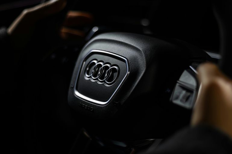 Detailed shot of the Audi steering wheel, showcasing elegant car branding. Captured in Toronto studio lighting.