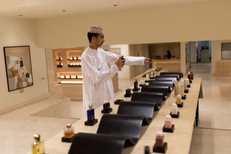 A man samples perfumes in a showroom in Muscat, Oman, March 17, 2026. REUTERS/Stelios Misinas