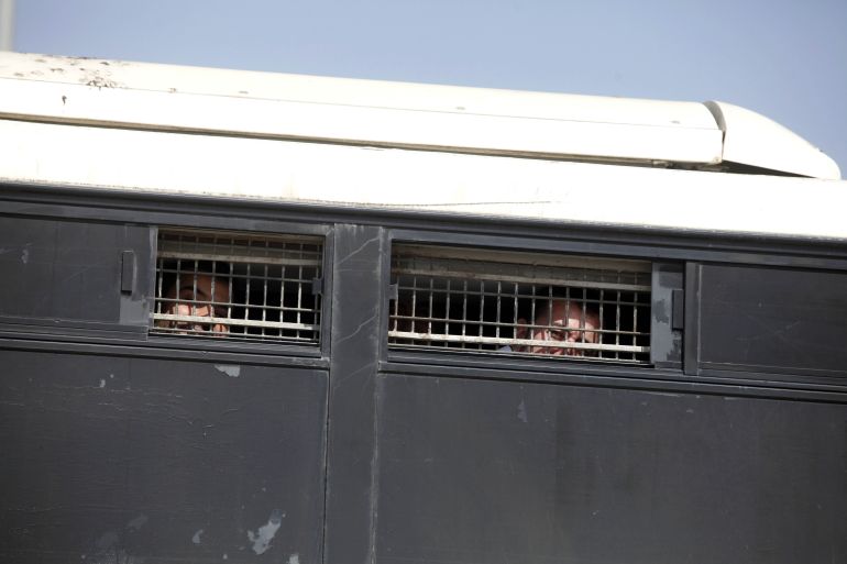 MITZPE RAMON, ISRAEL - OCTOBER 16: (ISRAEL OUT) Palestinian prisoners look out from an Israeli Prison Service bus as it leaves Nafha prison on October 16, 2011. in Mitzpe Ramon, Israel. IDF soldier Gilad Shalit is to be freed from 5 years of captivity in Gaza in an exchange deal which will see the release of 477 Palestinian prisoners in an initial deal with another 550 to freed after the return of Shalit. (Photo by Lior Mizrahi/Getty Images)