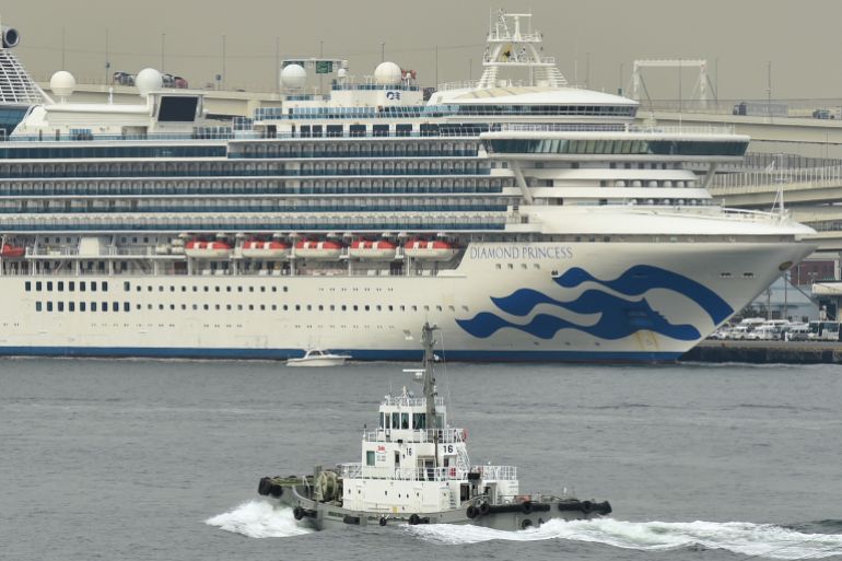 The Diamond Princess cruise ship (back) in quarantine due to fears of the new COVID-19 coronavirus, is seen at the Daikoku Pier Cruise Terminal in Yokohama on February 20, 2020. Two former passengers of the coronavirus-wracked Diamond Princess have died, local media reported, as fears mount about those who have left the ship after testing negative for the virus. (Photo by Kazuhiro NOGI / AFP) / The erroneous mention[s] appearing in the metadata of this photo by Kazuhiro NOGI has been modified in AFP systems in the following manner: changes dateline to [YOKOHAMA] instead of [HONG KONG], and changes slug in object name metadata to [JAPAN] instead of [HONG KONG]. Please immediately remove the erroneous mention[s] from all your online services and delete it (them) from your servers. If you have been authorized by AFP to distribute it (them) to third parties, please ensure that the same actions are carried out by them. Failure to promptly comply with these instructions will entail liability on your part for any continued or post notification usage. Therefore we thank you very much for all your attention and prompt action. We are sorry for the inconvenience this notification may cause and remain at your disposal for any further information you may require.