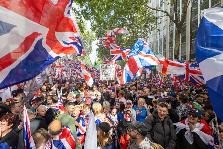 epa12962300 People gather in Kingsway ahead of a 'Unite the Kingdom' march and rally in London, Britain, 16 May 2026. The march is organized by Stephen Yaxley-Lennon, also known as Tommy Robinson, to call for a new coalition to 'Make Europe Great Again.' This protest is taking place at the same time as a 'Nakba 78: March for Palestine' in London. EPA/TAYFUN SALCI