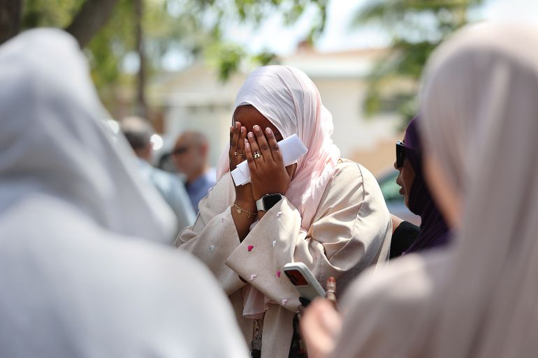 epa_6a0d9de24a64-1779277282 epaselect epa12975900 Hawaa Abdullah, weeps at Lindbergh Neighborhood Park, down the block from the Islamic Center of San Diego in San Diego, California, USA, 19 May 2026. Abdullah’s father, Amin Abdullah, who was a security guard at the center, was killed during the shootout on 18 May. EPA/JOHN GASTALDO